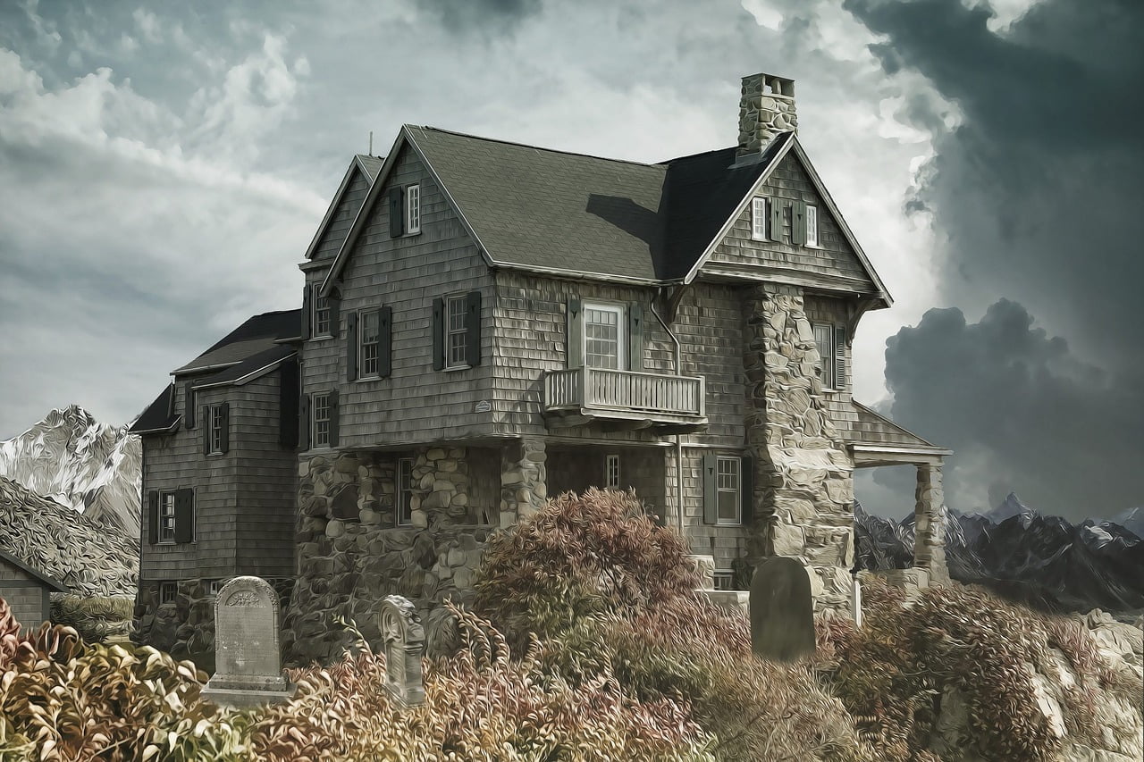 An imposing stone and wood house with shuttered windows, featuring a balcony and surrounded by a garden with headstones, under a stormy sky with distant mountains.