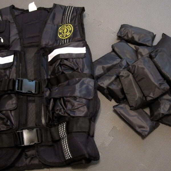 A black tactical vest with white reflective stripes and a badge on the front, next to a pile of separate pouches that appear to be weights, all laid out on a grey background.